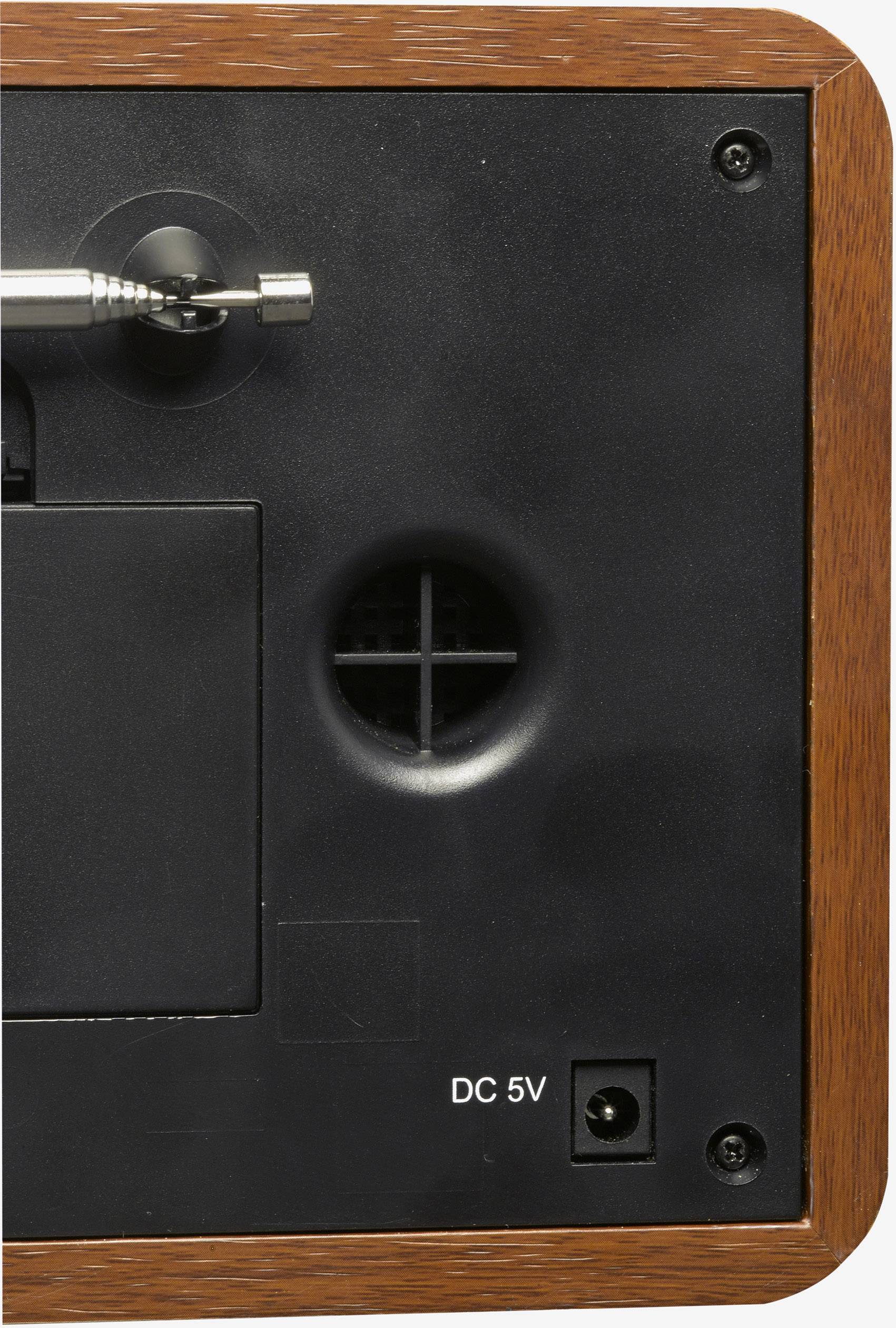 Dos d'un appareil électronique avec un cadre en bois. Connexions visibles : mini-jack, ouverture de ventilation circulaire et entrée DC 5V.