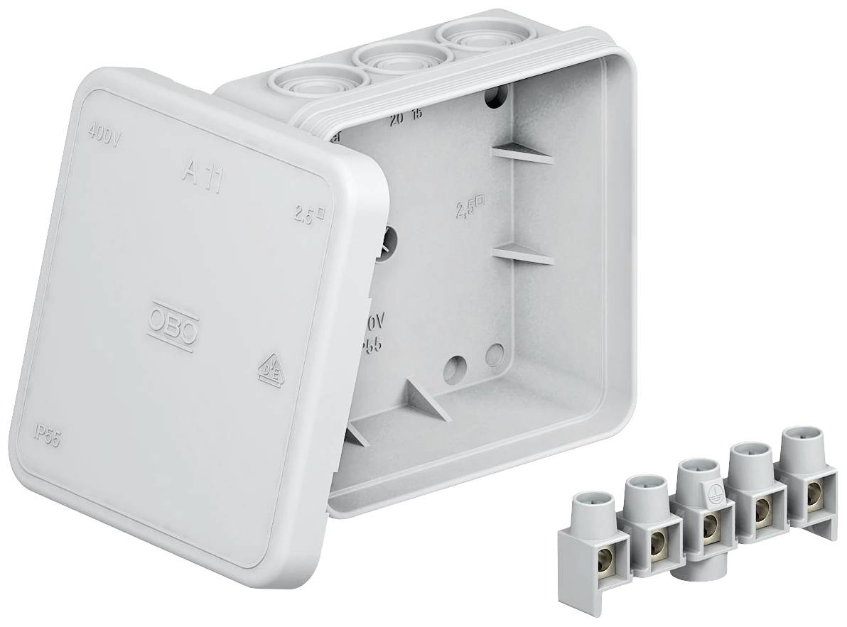 Boîte de distribution électrique grise avec couvercle retiré, quatre ouvertures rondes en haut et cinq points de connexion séparés à côté.