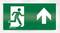 Un panneau de sortie de secours vert montre une personne courant vers la gauche, avec une flèche pointant vers le haut, indiquant le chemin d'évacuation.