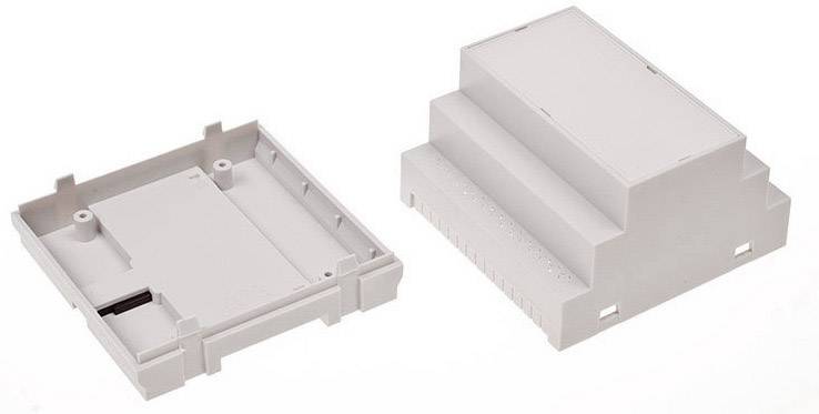 Boîtier gris, moitié gauche avec des emplacements électroniques, moitié droite avec un couvercle. Les deux moitiés sont identiques.