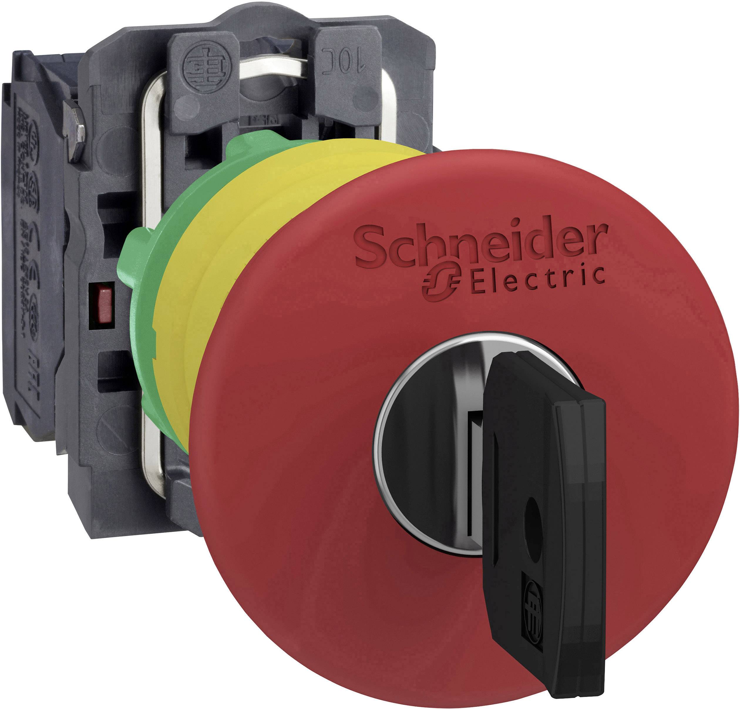 L'image montre un bouton d'arrêt d'urgence de Schneider Electric. Le commutateur est rouge avec des éléments jaunes et verts, permettant la désactivation des machines.