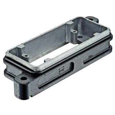 Un boîtier rectangulaire en métal, probablement une pièce de machine, avec des trous de fixation aux coins.