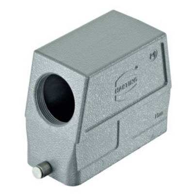 Boîtier métallique gris rectangulaire avec un trou de connexion rond sur la face avant et une structure de surface visible.
