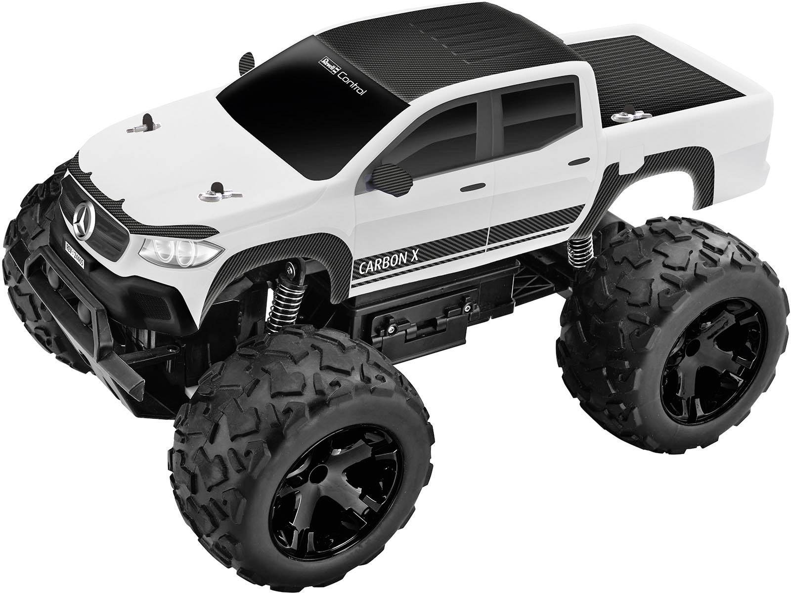 Un monster truck blanc, télécommandé, avec de grandes roues et un toit noir. Sur le côté est inscrit 'Carbon X'.