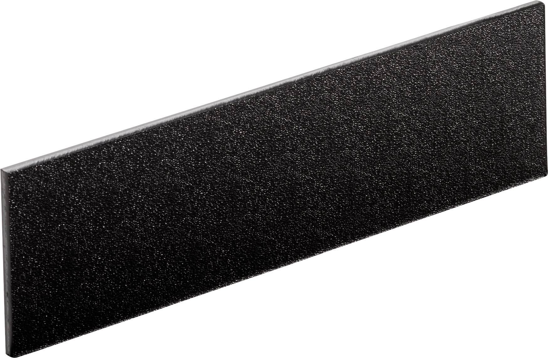 Carreau noir, rectangulaire, à surface granuleuse.