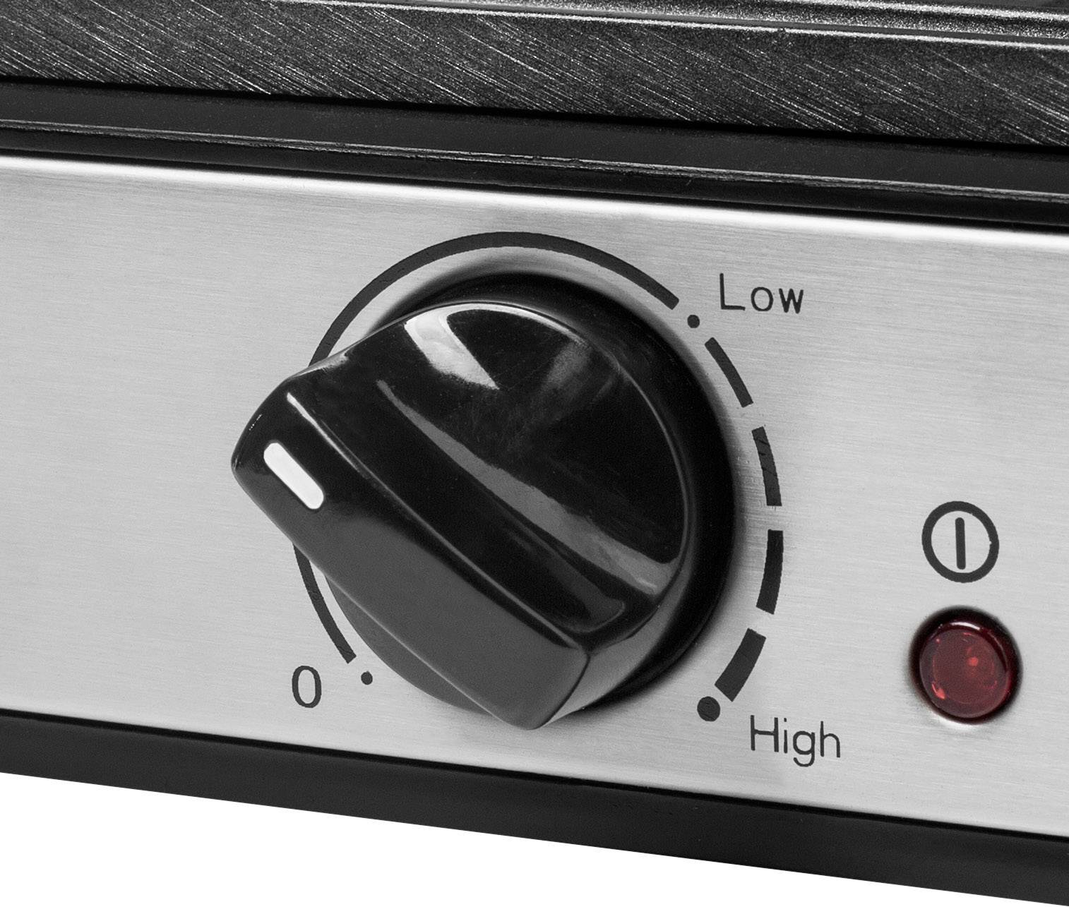 Bouton rotatif sur un appareil argenté avec les réglages « Low » et « High ». Une lumière rouge est visible à côté du bouton.