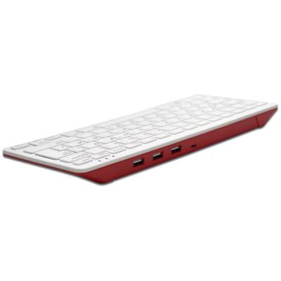 Clavier blanc avec des accents rouges, incliné sur le côté, montrant trois ports USB sur la droite.
