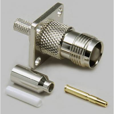 Quatre parties d'un connecteur coaxial HF : connecteur à surface striée, bague de serrage argentée, broche dorée, isolant blanc.