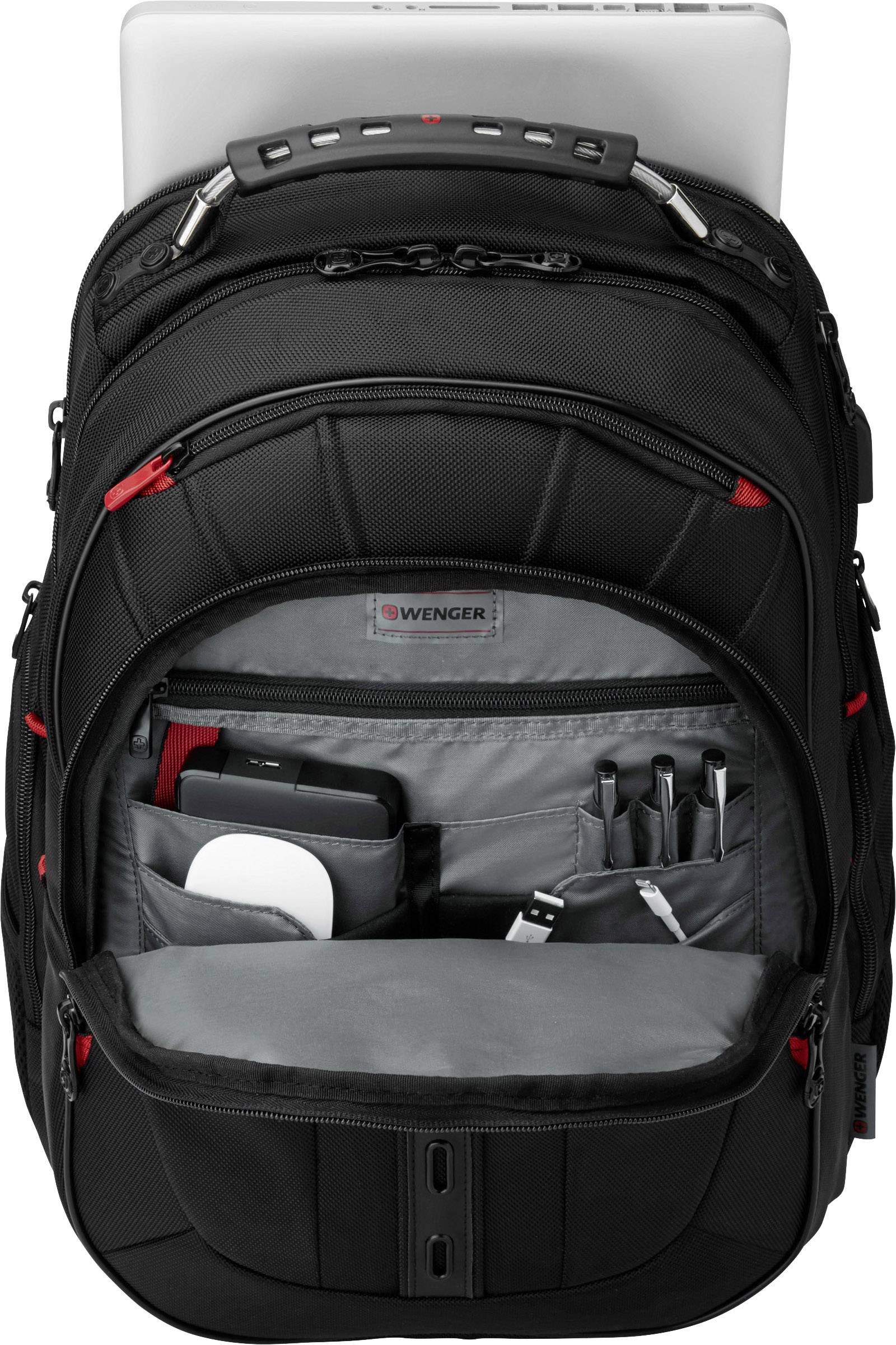 Sac à dos noir avec compartiment pour ordinateur portable, partiellement ouvert. On distingue des poches offrant de l'espace pour les appareils électroniques, stylos et accessoires.