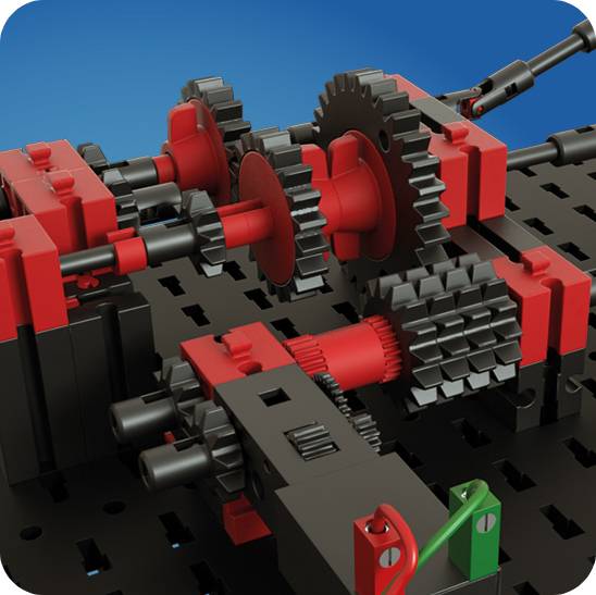 Un module d'engrenage complexe dans un kit de construction, montrant plusieurs engrenages imbriqués rouges et noirs sur une base noire.