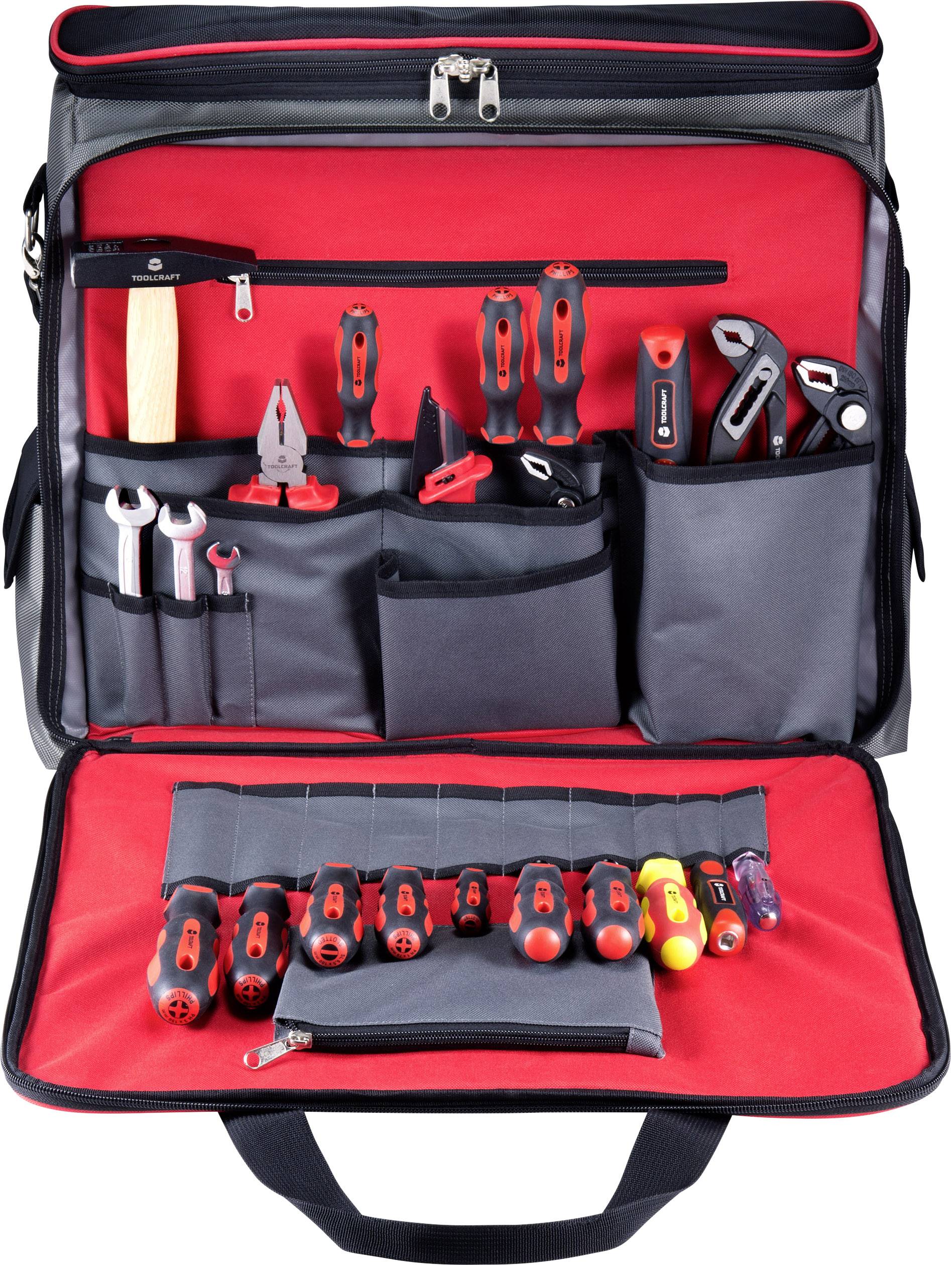 Un sac à outils noir avec des compartiments intérieurs rouges présente divers outils, dont des tournevis, des pinces et des clés à molette.
