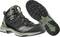 Chaussures de randonnée noires avec accent vert et semelle claire, adaptées aux activités de plein air. Nom de la marque visible sur le côté.