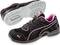 Chaussure de sport noire avec des touches roses et semelle épaisse, présentée de côté et par en dessous. Design moderne pour activités sportives.