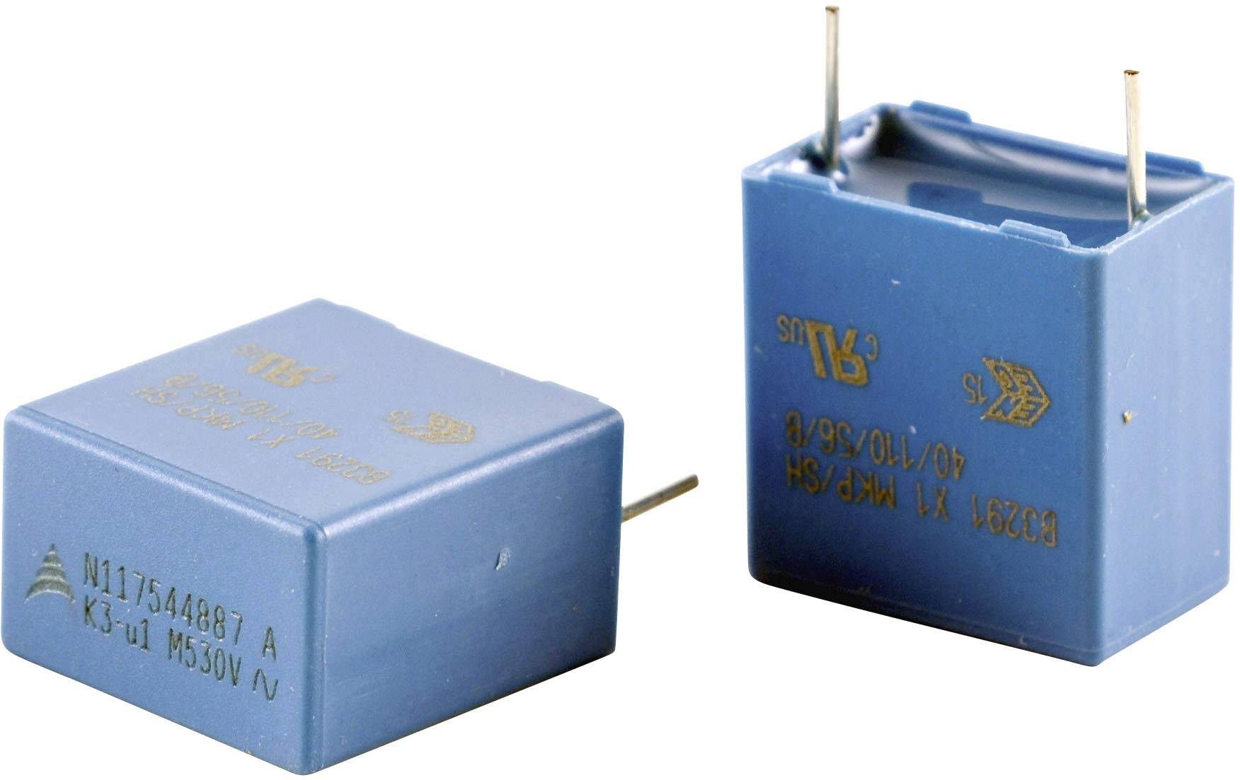 Deux condensateurs bleus avec des bornes argentées, portant des spécifications techniques imprimées sur leurs boîtiers.