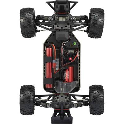 Vue supérieure d'un châssis de voiture télécommandée avec électronique, batteries et suspensions de roues ouvertes. Des pneus robustes et profilés sont visibles.