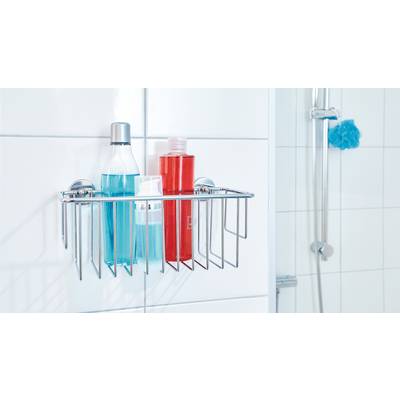 Panier de douche en métal avec deux bouteilles colorées, installé sur un mur carrelé de salle de bain à côté d'une douche.