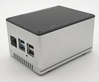 Un petit ordinateur rectangulaire avec plusieurs ports, dont USB et Ethernet, sur une surface blanche.
