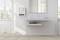 Salle de bain claire avec un lavabo et un porte-serviettes, un miroir au-dessus. Un appareil sur le mur indique la température.