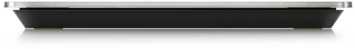 Vue latérale d'un ordinateur portable fin et fermé, posé sur une surface blanche.