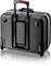 Valise rigide noire avec poignée télescopique et roulettes, debout verticalement. Idéale pour les voyages, robuste et facile à transporter.