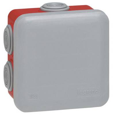 Une boîte de dérivation électrique carrée grise de marque Legrand, avec un fond rouge et des passages de câbles, de protection IP55.