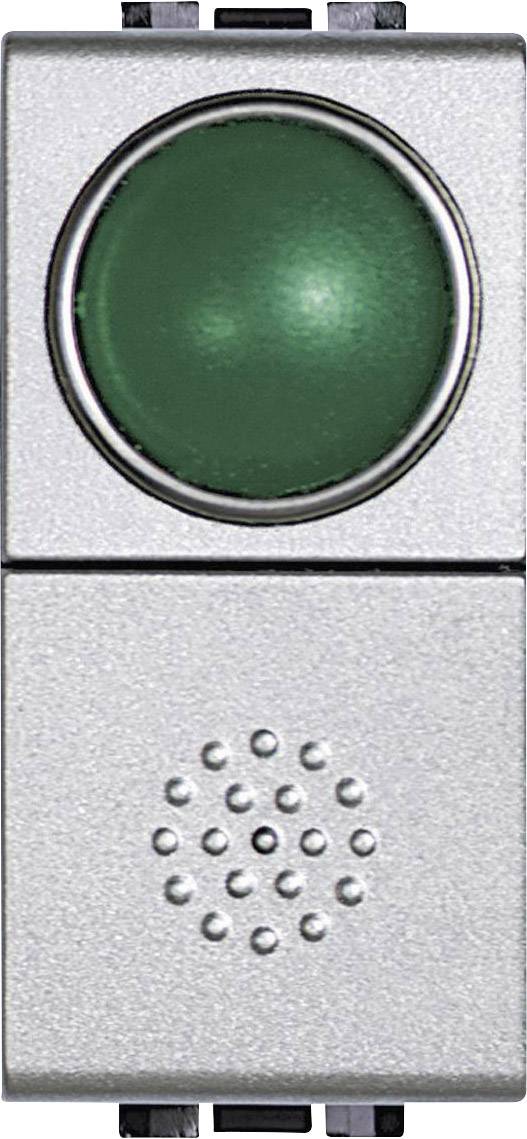 Bouton-poussoir vert sur une plaque métallique argentée avec une découpe circulaire plus petite en dessous, probablement destinée aux dispositifs auditifs.