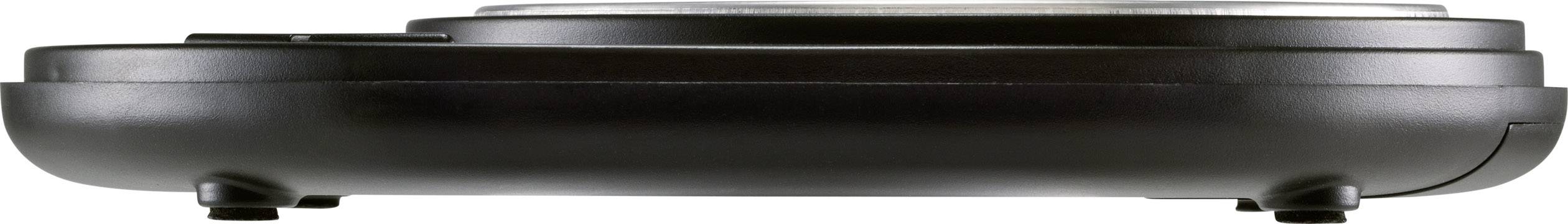 Appareil électrique noir et rond sur des pieds, probablement un appareil de cuisine comme un gaufrier ou un sandwich-grill, présenté de profil.