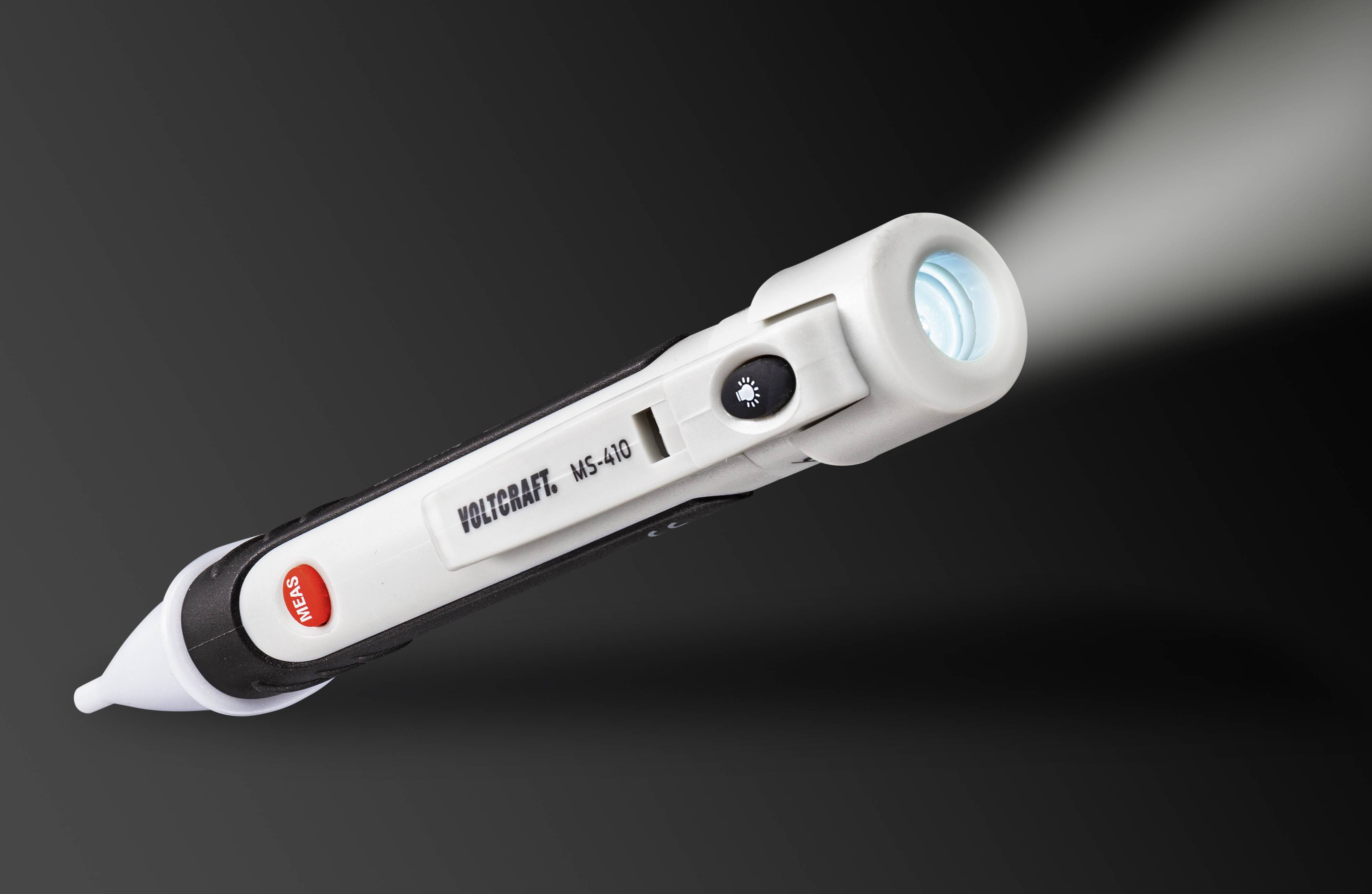 Testeur de tension en forme de stylo avec pointe lumineuse sur fond noir, utilisé pour détecter la présence de tension électrique.