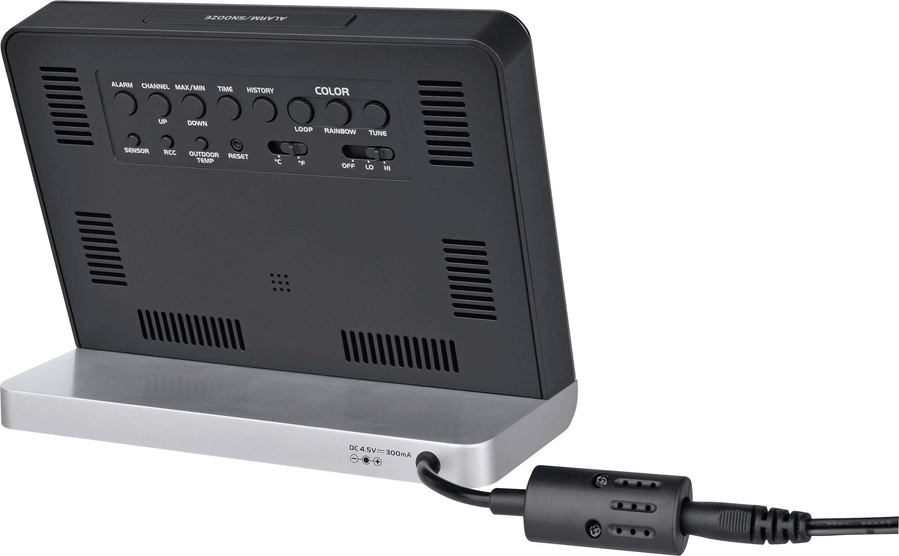 Un appareil électronique noir avec plusieurs touches et une base de support argentée, relié à un câble noir.