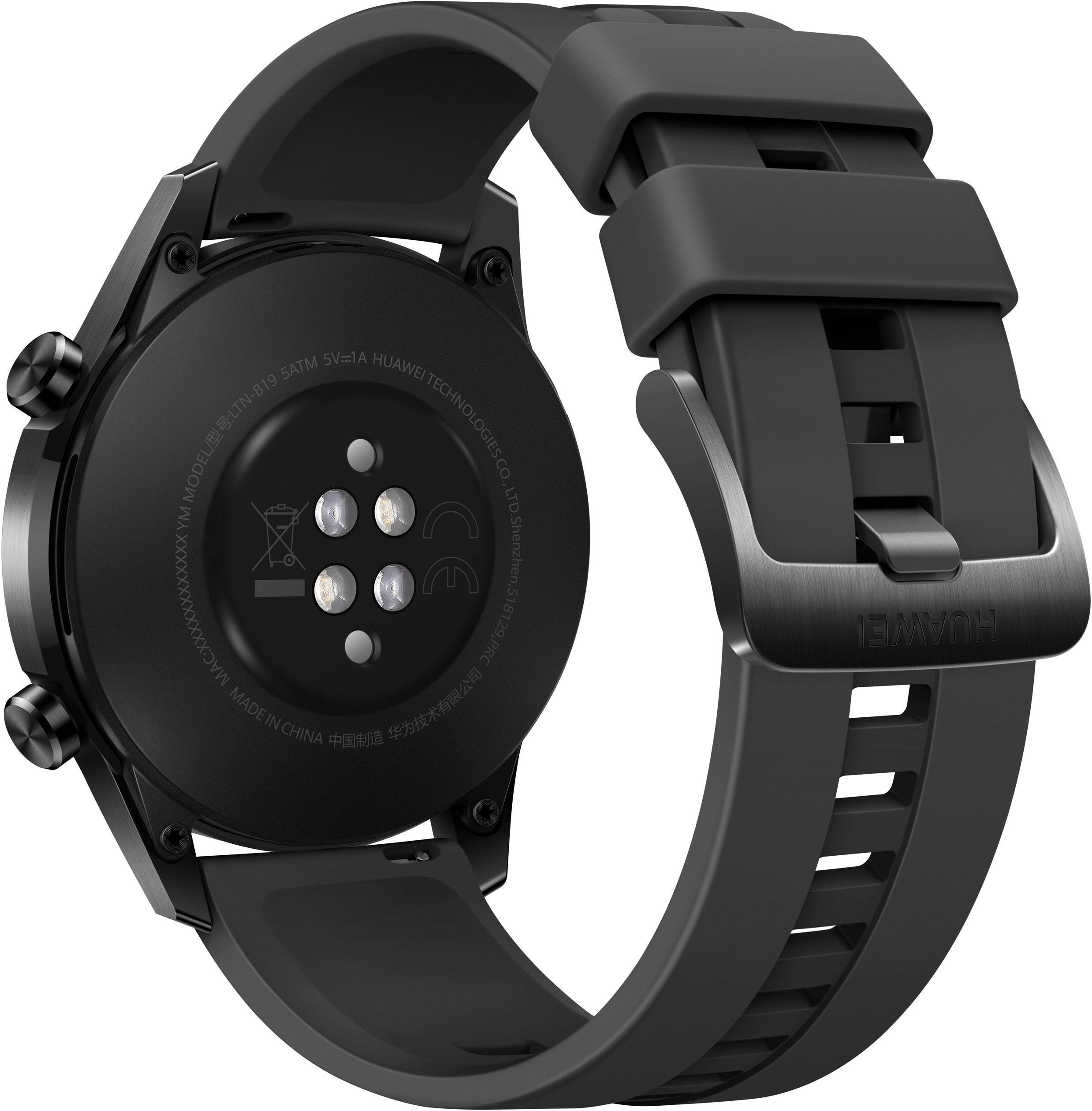 Une montre-bracelet noire avec un bracelet en silicone, la face arrière avec des capteurs visible.