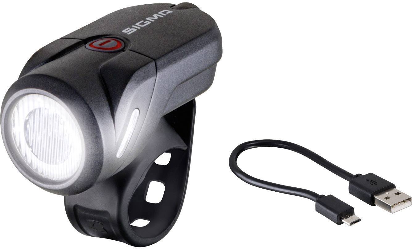 Un éclairage noir pour vélo avec câble de chargement USB. L'éclairage dispose d'un design compact et se fixe au moyen d'une sangle en caoutchouc.