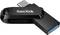 Une clé USB noire avec le logo 'SanDisk'. La clé possède une connectique USB-C et est posée sur une surface blanche.