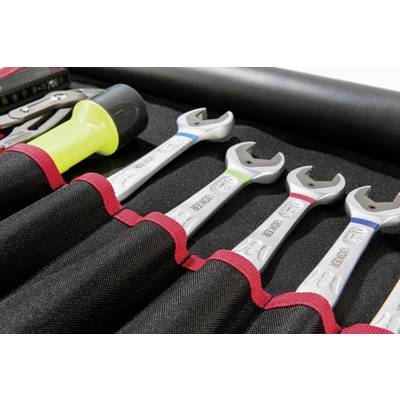 Un ensemble d'outils comprenant quatre clés à fourche dans un sac en tissu noir, chaque clé ayant une poignée de couleur différente.