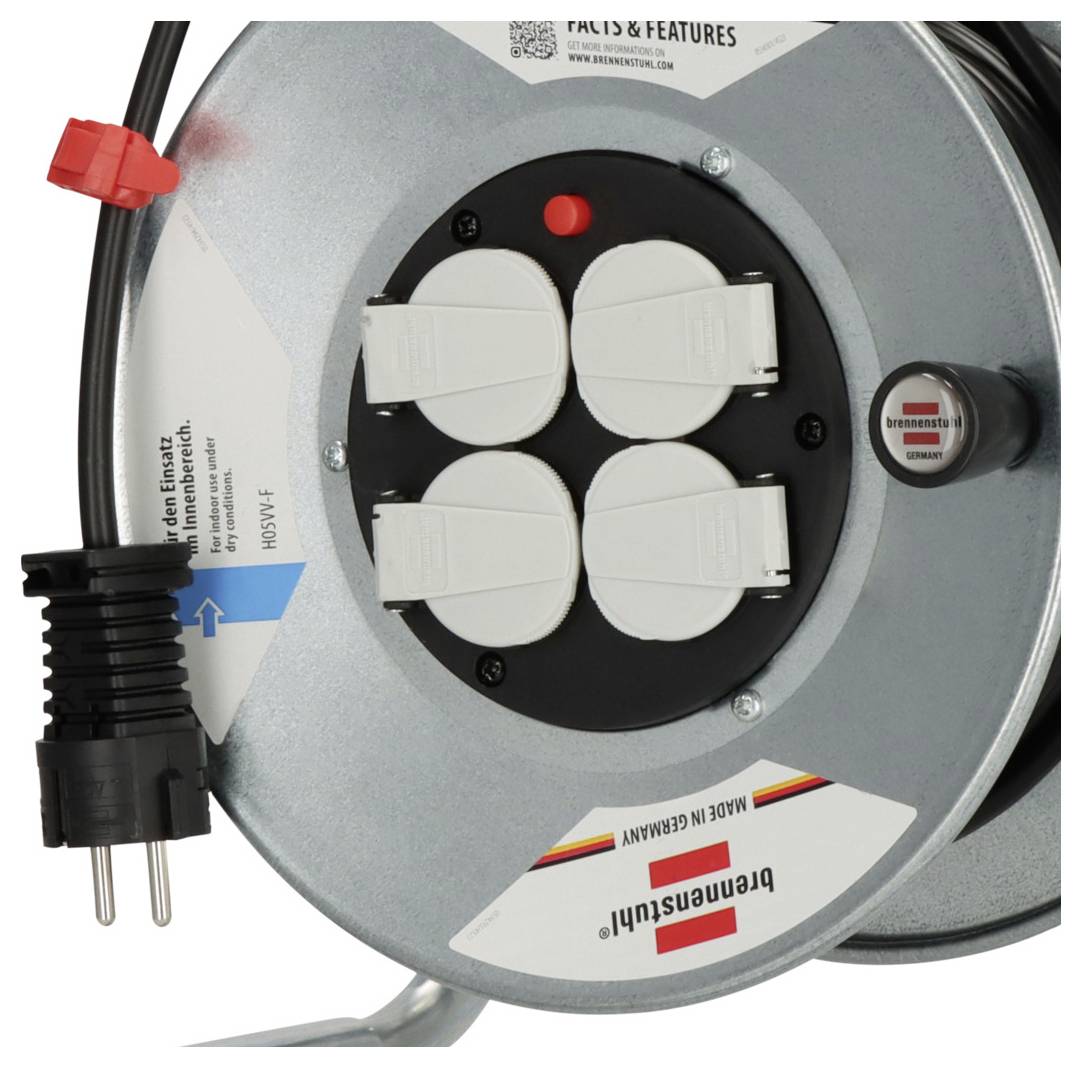 Gros plan d'une bobine de câble électrique rond avec quatre prises recouvertes, une fiche de cordon d'alimentation et un interrupteur marche/arrêt rouge.