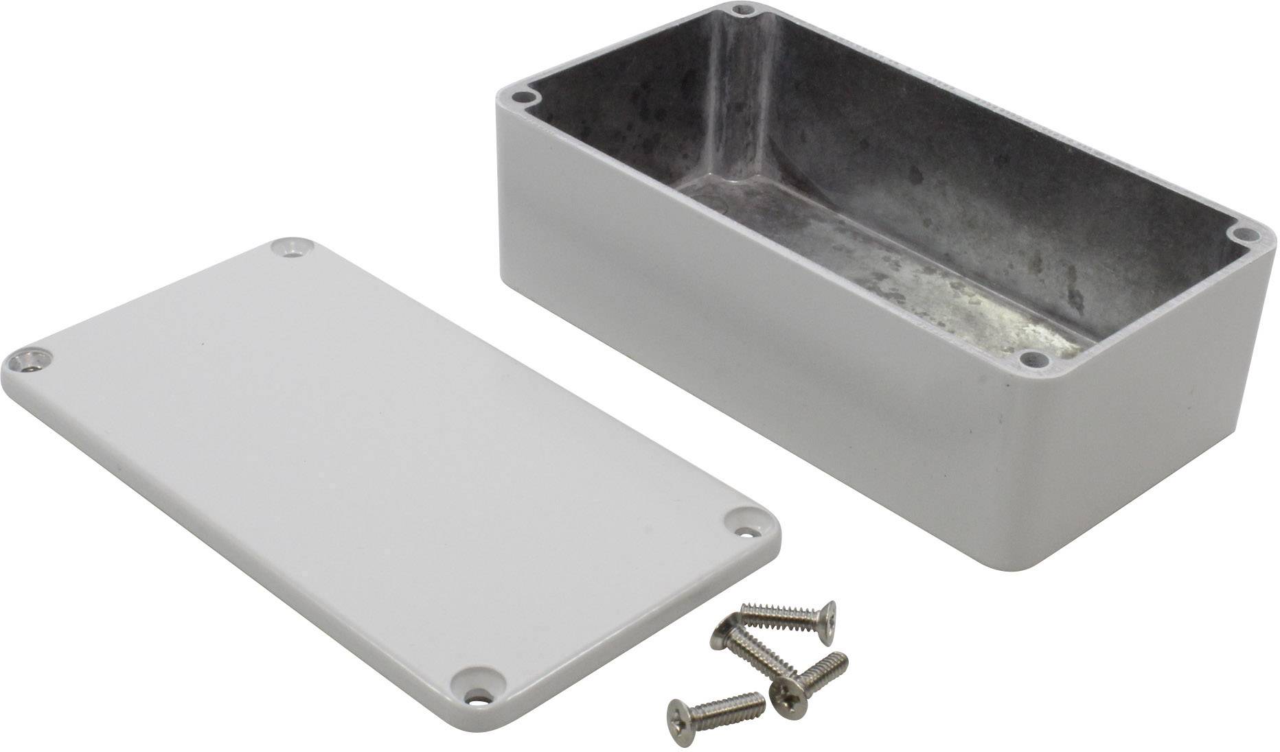 Boîtier métallique avec couvercle retiré et quatre vis, adapté pour accueillir des composants électroniques.