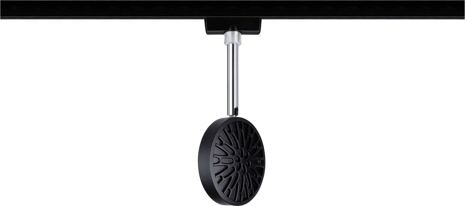 Une roue noire avec un motif estampé est fixée au centre d'une tige métallique suspendue vers le bas depuis une surface noire.