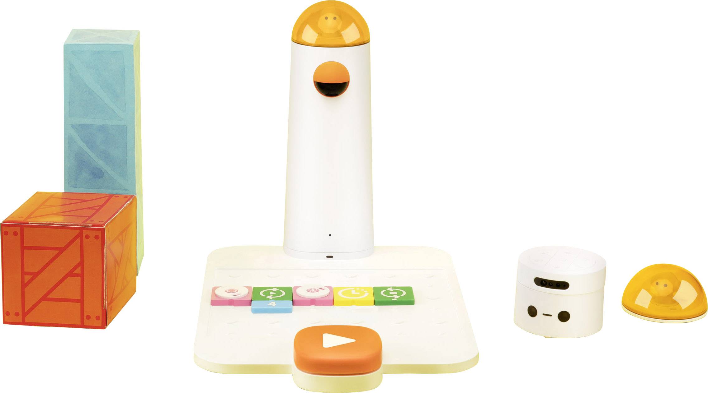 Ensemble de jeu comprenant des dés colorés, un appareil interactif avec un visage et une casquette orange, ainsi qu'un clavier avec des symboles.
