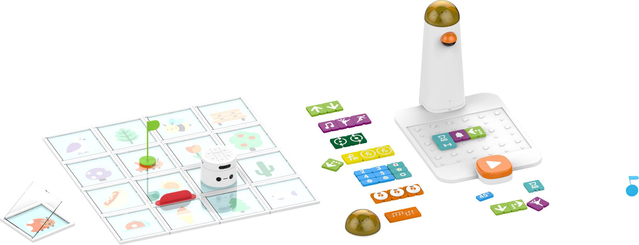 Kit de robot jouet avec cartes de programmation et tapis à grille. Robot sur le tapis, pile de cartes montrant des symboles de direction et d'action.