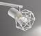 Une lampe de plafond moderne avec un cadre métallique géométrique entourant une ampoule, sur un fond gris.