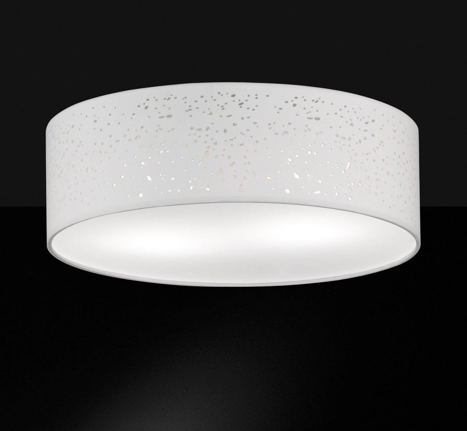 Plafonnier blanc, rond, avec un motif perforé sur un fond noir. La lampe diffuse une lumière douce et uniforme.