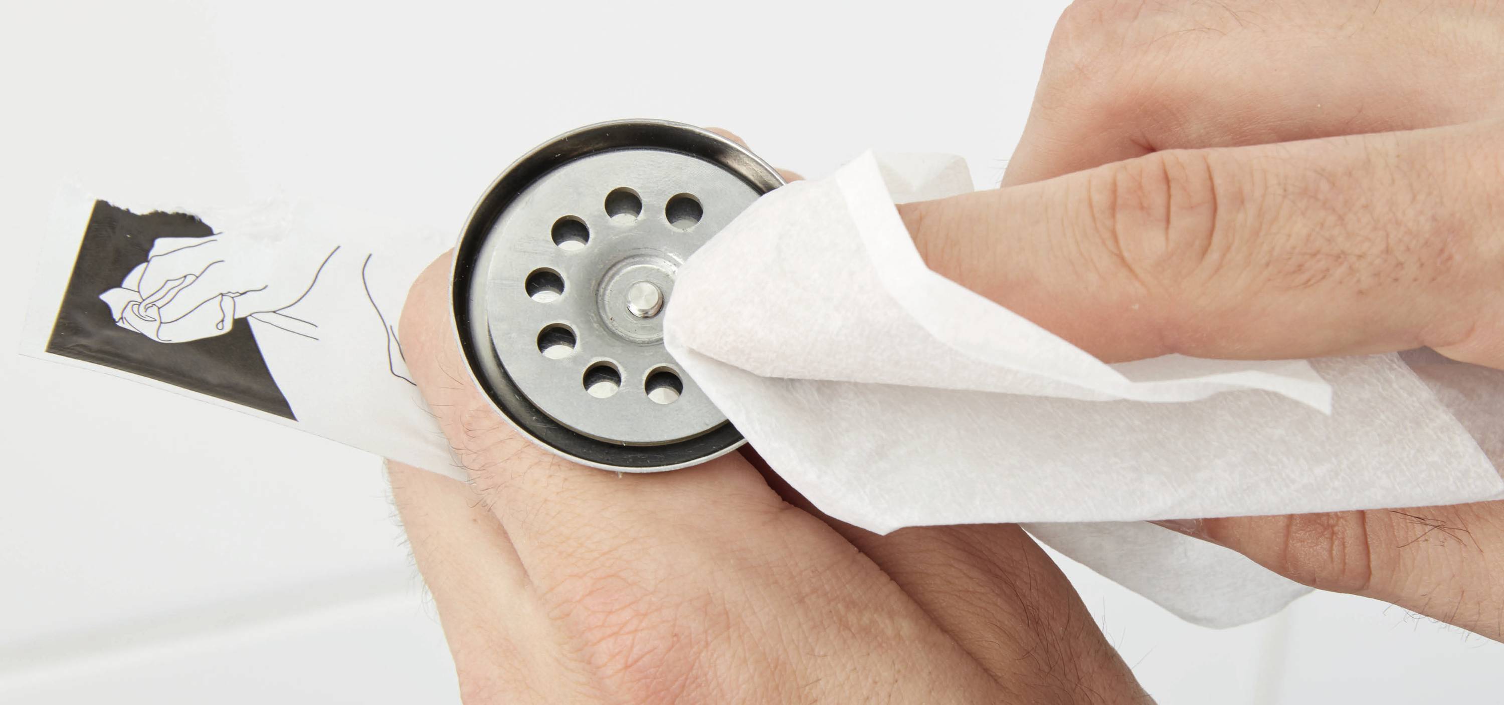 Une main est essuyée par un distributeur d'essuie-mains avec un papier.