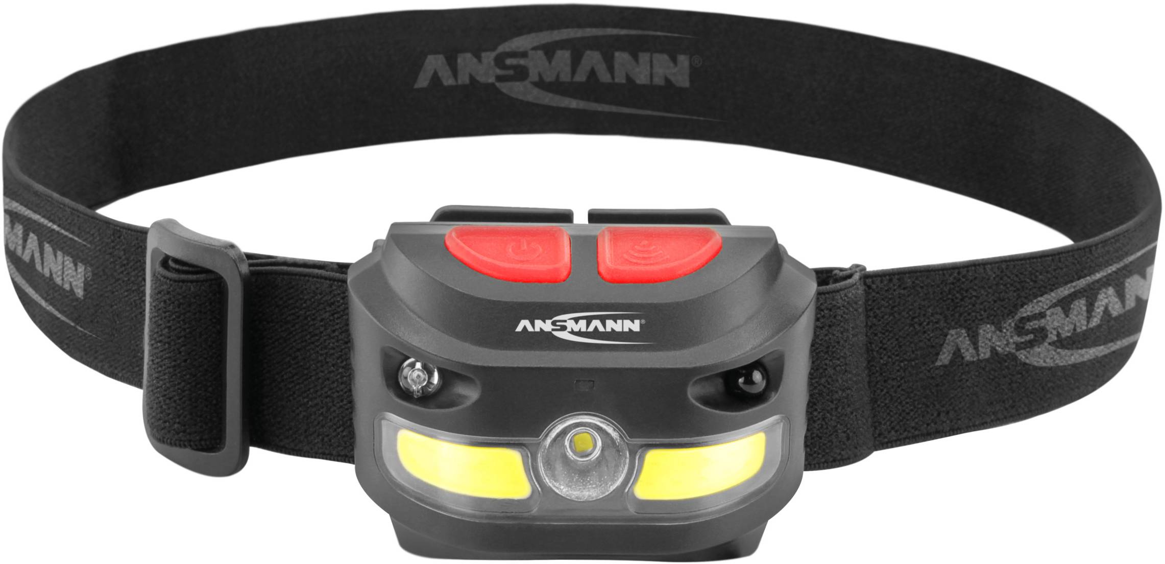 Lampe frontale avec bandeau noir, deux boutons rouges et unité lumineuse jaune. Marque 'Ansmann' visible sur la lampe.