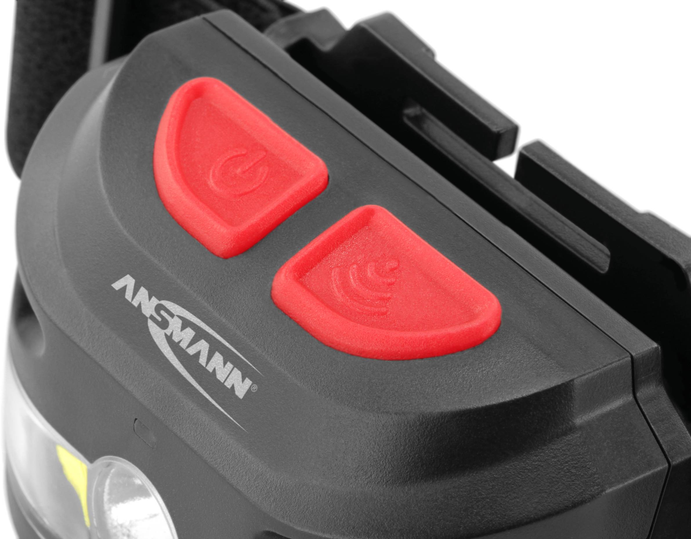 Lampe portable avec deux boutons rouges pour marche/arrêt et signal, nom de marque 'Ansmann' visible. Idéale pour diverses situations d'éclairage.