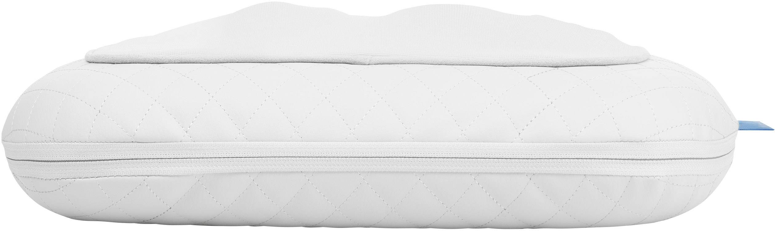 Un coussin blanc, horizontal, avec un motif matelassé et une fermeture éclair, présentant un bord supérieur légèrement surélevé.