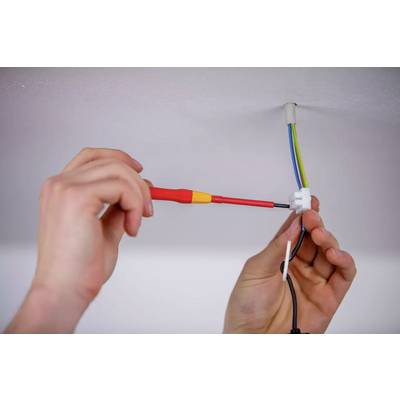 Quelques mains installent un câble électrique au plafond. Un tournevis est utilisé pour sécuriser les connexions.