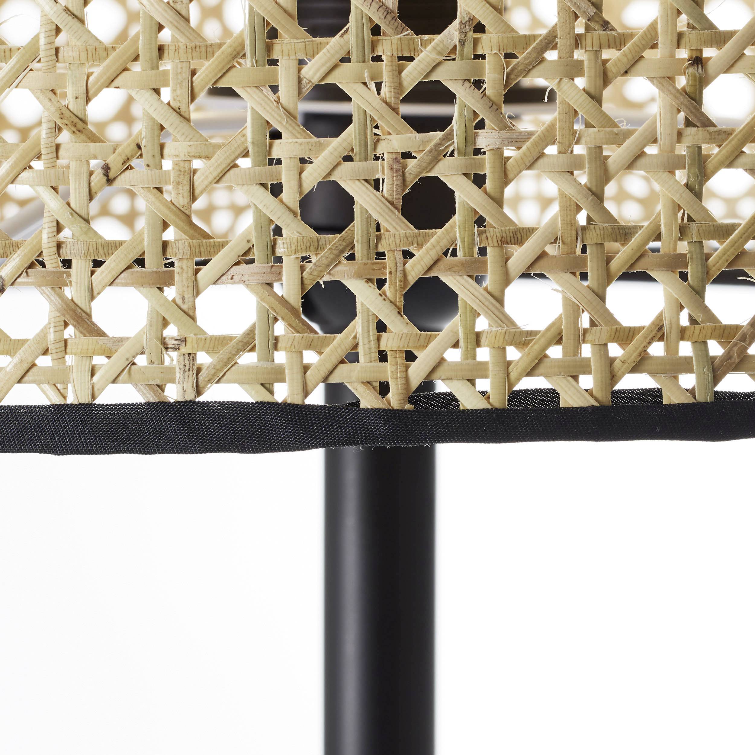 Motif tressé en rotin sur une chaise avec pied en métal noir.