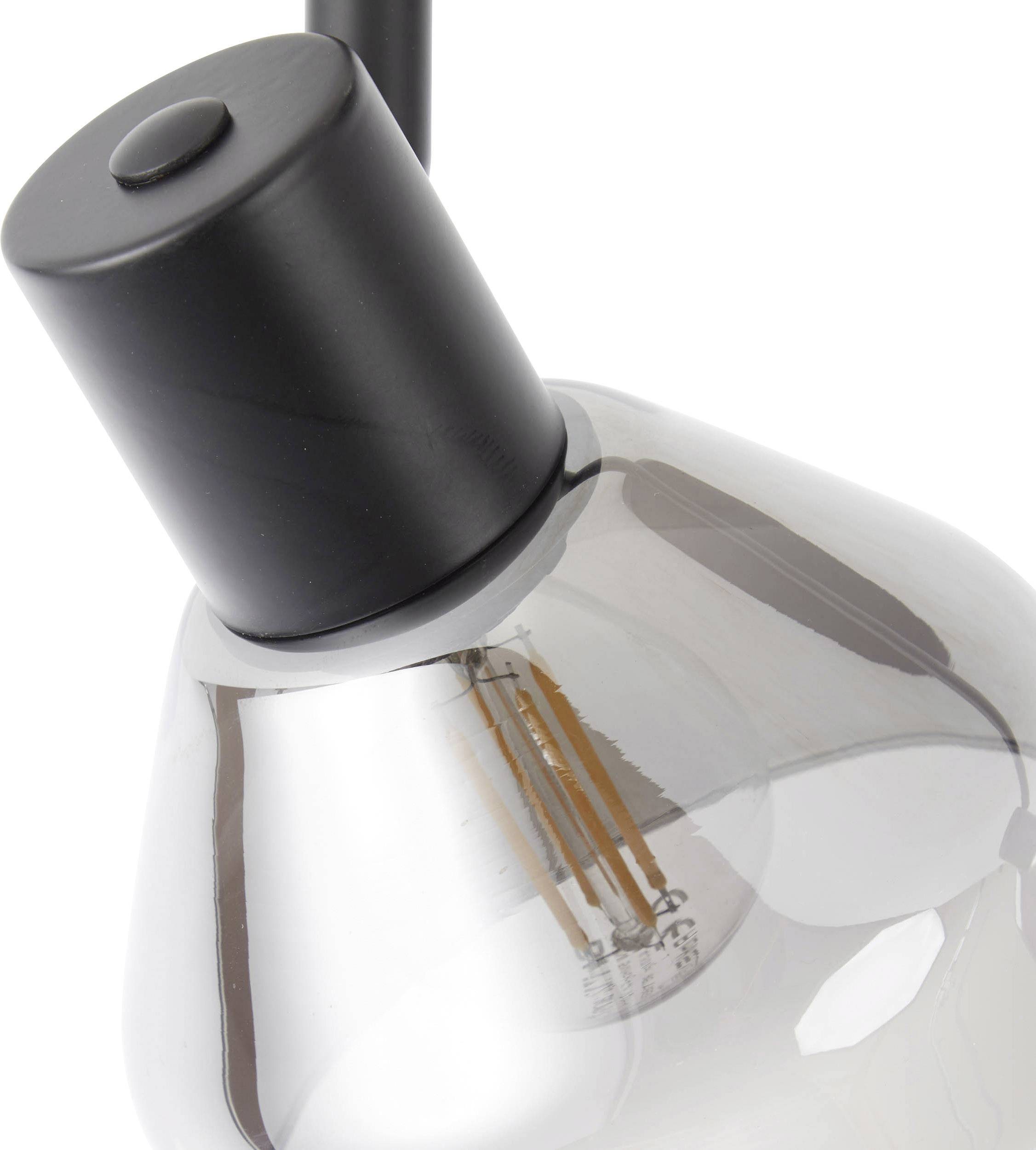 Gros plan d'une ampoule moderne grise avec un culot noir. Les filaments à l'intérieur sont visibles.