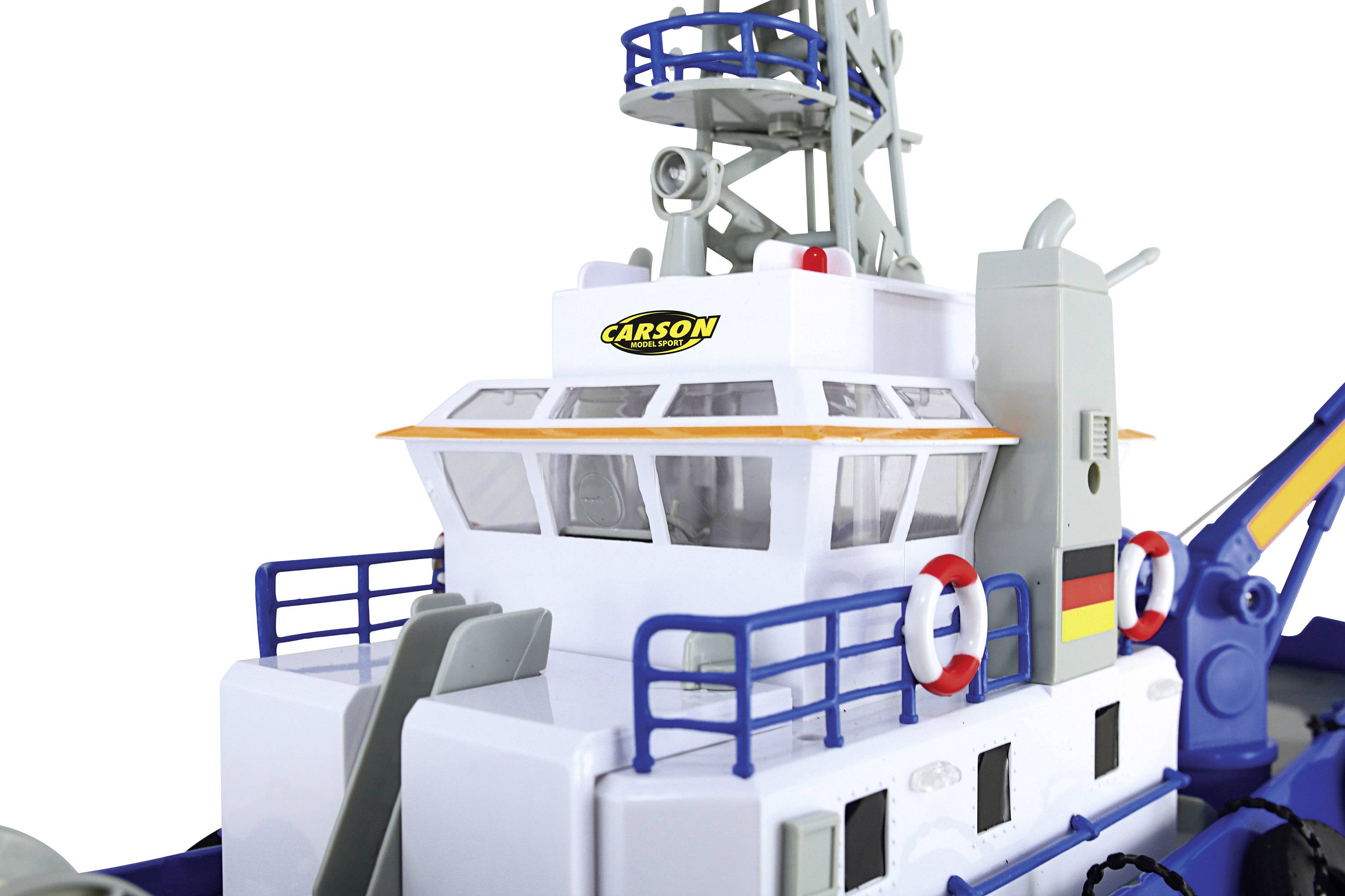 Jouet de bateau avec des détails tels que des bouées de sauvetage et une tour, le logo 'Carson' sur le cockpit, dans les couleurs blanc et bleu.