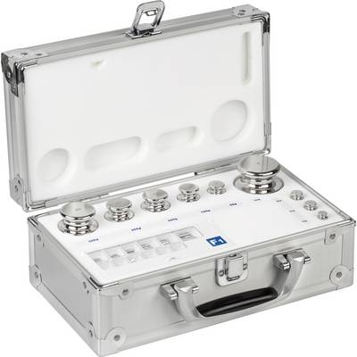Valise argentée ouverte contenant différentes pièces de poids et des compartiments à l'intérieur. Les poids varient en taille.
