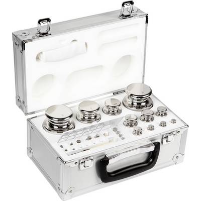 Valise ouverte en aluminium contenant des poids de précision de différentes tailles, polis et soigneusement rangés dans une mousse de protection.